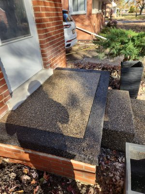 Exposed Aggregate Porch - We are proud to showcase a standout project completed in Troy, featuring an exquisite exposed aggregate walkway and porch. The design boasts a sophisticated black stained border that perfectly frames the beautifully textured surface of the exposed aggregate. This decorative concrete technique not only enhances the visual appeal but also provides a durable and low-maintenance solution. The project includes expertly crafted exposed aggregate steps, offering a seamless transition from walkway to porch. Each element is meticulously finished to ensure a cohesive and polished aesthetic that complements the surrounding architecture. Exposed Aggregate Porch - We are proud to showcase a standout project completed in Troy, featuring an exquisite exposed aggregate walkway and porch. The design boasts a sophisticated black stained border that perfectly frames the beautifully textured surface of the exposed aggregate. This decorative concrete technique not only enhances the visual appeal but also provides a durable and low-maintenance solution. The project includes expertly crafted exposed aggregate steps, offering a seamless transition from walkway to porch. Each element is meticulously finished to ensure a cohesive and polished aesthetic that complements the surrounding architecture.