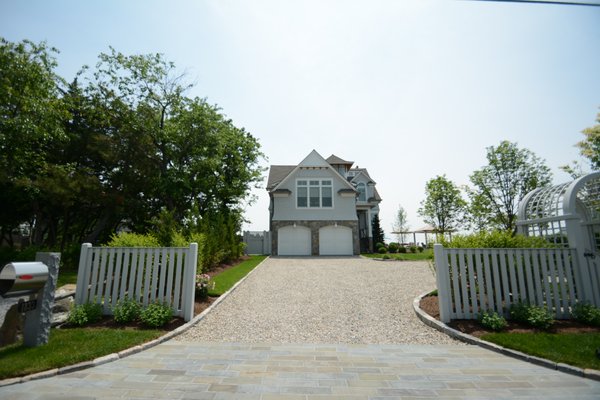 Beach Side Oasis - We had the pleasure of designing this double lot site from a sandy slate.  New masonry aprons, curbing walks and patios.  Garden structures ajoined with lush flowering trees and gardens make this site welcoming and relaxing.