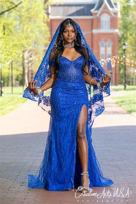 Prom Photo Shoot - The photo shoot features a young lady in a blue Hindu-inspired dress on a sunny college campus. She poses gracefully amid lush lawns and classic architecture. The vibrant dress catches the light beautifully. The setting and natural lighting create a joyful, elegant atmosphere. Prom Photo Shoot - The photo shoot features a young lady in a blue Hindu-inspired dress on a sunny college campus. She poses gracefully amid lush lawns and classic architecture. The vibrant dress catches the light beautifully. The setting and natural lighting create a joyful, elegant atmosphere.