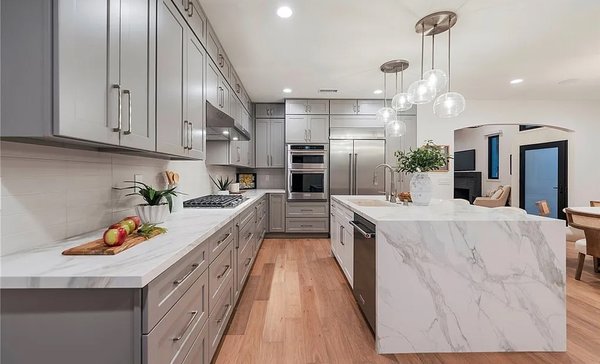 Master Kitchen Remodel in Newport Beach, California - This Newport Beach, Orange County Kitchen remodel blends timeless shaker-style cabinetry with a sleek, contemporary aesthetic.  

MTD Kitchen OC delivered a complete kitchen transformation featuring custom grey shaker cabinets, a dramatic waterfall island, and integrated storage solutions.
