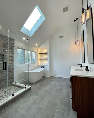 A Bright & Airy Spa Retreat in Westfield, NJ! - We completely transformed this master bathroom, capitalizing on the natural light from the skylight and large window. This custom space features a luxurious free-standing soaking tub, an expansive glass-enclosed walk-in shower with a natural stone pebble floor and stacked stone accent wall, and a custom walnut dual vanity with contemporary fixtures. The high ceilings and subtle stone textures create a calming, five-star hotel feel right at home. A Bright & Airy Spa Retreat in Westfield, NJ! - We completely transformed this master bathroom, capitalizing on the natural light from the skylight and large window. This custom space features a luxurious free-standing soaking tub, an expansive glass-enclosed walk-in shower with a natural stone pebble floor and stacked stone accent wall, and a custom walnut dual vanity with contemporary fixtures. The high ceilings and subtle stone textures create a calming, five-star hotel feel right at home.