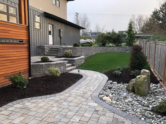 Full Landscape Install - This project was for a brand new home. A lot going on here. Site prep, soil, water feature, retaining walls, stairs plantings, sod installation, irrigation. We are still doing our full service grounds care program at this satisfied clients home. Full Landscape Install - This project was for a brand new home. A lot going on here. Site prep, soil, water feature, retaining walls, stairs plantings, sod installation, irrigation. We are still doing our full service grounds care program at this satisfied clients home.