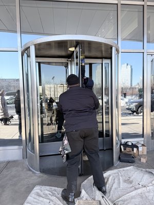 Revolving door weatherstripping replacement and preventative maintence - The existing weather stripping on the revolving door has deteriorated due to normal wear and exposure to the elements, allowing drafts, moisture, and debris to enter the building. We will remove the worn weather stripping and install new heavy-duty replacement weather stripping, making any necessary adjustments to ensure a proper seal while maintaining smooth, reliable operation of the revolving door. Upon completion, the door will be tested to verify proper function and improved weather protection. Revolving door weatherstripping replacement and preventative maintence - The existing weather stripping on the revolving door has deteriorated due to normal wear and exposure to the elements, allowing drafts, moisture, and debris to enter the building. We will remove the worn weather stripping and install new heavy-duty replacement weather stripping, making any necessary adjustments to ensure a proper seal while maintaining smooth, reliable operation of the revolving door. Upon completion, the door will be tested to verify proper function and improved weather protection.