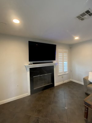 Custom TV installed over fireplace with recessed media box behind and 7.2.2 home theater speaker retrofit - Client request requested that we install a 65 inch OLED TV above fireplace where there was no existing electrical and to add 6 additional in ceiling 8” speakers in another area to complete a 7.2.2 Dolby Atmos surround-picture shown or from start to finish a project with our electrical partners installing the outlet in our Drywall team, finishing all open walls. Custom TV installed over fireplace with recessed media box behind and 7.2.2 home theater speaker retrofit - Client request requested that we install a 65 inch OLED TV above fireplace where there was no existing electrical and to add 6 additional in ceiling 8” speakers in another area to complete a 7.2.2 Dolby Atmos surround-picture shown or from start to finish a project with our electrical partners installing the outlet in our Drywall team, finishing all open walls.