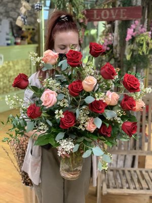 Celebrating Love - Treat them to a Love N' Bloom luxury High Petal Count rose arrangement this Valentine's Day. She will just love the lush and romantic palette of this premium Rose Floral Arrangement. This mixture of high petal count Premium Roses is designed with mixed premium greens, fragrant white Wax Flower creates a Romantic Essence to any room.