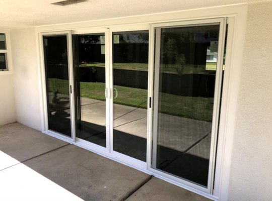 Sliding glass doors and fixed panel windows with Doggie door installation. (2020) - Beautiful sliding glass doors and a custom size Doggie door.