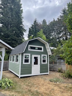 Barn Style Shed 12W X 20D - This Barn Shed located in Kirkland incorporates many of the customizations we offer here at The Original Mini Barns.
Our customer was looking for an area to serve as a storage, office, and living space while creating a warm and welcoming ambiance. We were definitely able see to it that this customer received everything that they requested. See below the breakdown of the options chosen by this customer to achieve their one-of-a-kind design.
EXTERIOR DETAILS:
Siding:
Hardie Lap Cedarmill texture.
Roof:
Architectural Black Composite Roof.
Doors:
Single ½ Glass 2-Panel Fiberglass Door with Weatherguard Jamb (front wall).
Windows:
1-Picture 6W X 1.5H Window (front wall).
2-Single-Hung 2W X 3H Windows (front wall).
3-Slider 4W X 3H Windows (left wall).
1-Octagon 18” Window with Grids (back wall).
1-Picture 6W X 1H Window (back wall).
Exterior Options/Additions:
Lattice with Mesh Skirting Around the Bottom of the Shed.
Painting Package (customer provides paint color(s) & Garden Solutions will paint).
INTERIOR OPTIONS:
Siding:
Natural Pine Tongue and Groove.
Interior Options/Additions:
12W X 4D Loft.
SnapLock Flooring (customer provided Garden Solutions installs).
Insulation Package.
Interior Electrical Package.
Interior Heating Package. Barn Style Shed 12W X 20D - This Barn Shed located in Kirkland incorporates many of the customizations we offer here at The Original Mini Barns.
Our customer was looking for an area to serve as a storage, office, and living space while creating a warm and welcoming ambiance. We were definitely able see to it that this customer received everything that they requested. See below the breakdown of the options chosen by this customer to achieve their one-of-a-kind design.
EXTERIOR DETAILS:
Siding:
Hardie Lap Cedarmill texture.
Roof:
Architectural Black Composite Roof.
Doors:
Single ½ Glass 2-Panel Fiberglass Door with Weatherguard Jamb (front wall).
Windows:
1-Picture 6W X 1.5H Window (front wall).
2-Single-Hung 2W X 3H Windows (front wall).
3-Slider 4W X 3H Windows (left wall).
1-Octagon 18” Window with Grids (back wall).
1-Picture 6W X 1H Window (back wall).
Exterior Options/Additions:
Lattice with Mesh Skirting Around the Bottom of the Shed.
Painting Package (customer provides paint color(s) & Garden Solutions will paint).
INTERIOR OPTIONS:
Siding:
Natural Pine Tongue and Groove.
Interior Options/Additions:
12W X 4D Loft.
SnapLock Flooring (customer provided Garden Solutions installs).
Insulation Package.
Interior Electrical Package.
Interior Heating Package.