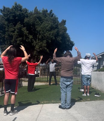 Victory House - Once a week, I visit Victory House, a facility dedicated to the transition of justice-impacted individuals to self-sufficiency and positivity. My role involves teaching guided meditations and conducting Qigong movement sessions. These practices are designed to help the men achieve mental stability and prepare for life beyond the confinements of prison and halfway houses.

Program Objectives:
- Mental Stability: Utilizing guided meditations to foster a sense of calm and mental clarity.
- Physical and Emotional Balance: Incorporating Qigong movements to promote physical health and emotional well-being.
- Life Skills Development: Providing tools and techniques to help participants navigate the challenges of reintegration into society.

Activities:
- Guided Meditations: Each session includes a period of guided meditation to help participants develop mindfulness and reduce stress.
- Qigong Movement: We practice Qigong exercises, which are gentle movements designed to improve energy flow and overall health.
- Discussion and Reflection: Sessions often include time for discussion and reflection, allowing participants to share their experiences and insights.

Impact:
- Improved Mental Health: Regular participation in these sessions can lead to reduced anxiety, better emotional regulation, and improved mental health.
- Enhanced Physical Well-being: Qigong exercises support physical fitness and can help alleviate stress-related physical ailments.
- Preparation for Reentry: The skills learned in these sessions aid in preparing the men for the demands and challenges they will face as they reenter society.

This holistic approach not only supports the men during their stay at Victory House but also equips them with lifelong tools for personal growth and resilience.