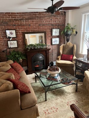 Alida's Suite - “Alida’s Suite” (Mon-Thurs $165, Fri-Sun $180 (2 night min) Applicable Sales Tax + 10% Service Charge per room. Weekend rates apply for all major holidays.

(One Night if available on request with $25 Charge, plus applicable tax & 10% Service Charge.) Please call directly 347-744-9322 or submit the "One Night Request Form online, under BOOK NOW!

There is a private side entrance from the side porch to the suite and access to all 3 gardens on the premises. One parking space for each room. If you have more than one car, please let me know so we can make arrangements for you.

This cheerful Suite is located on the 1st floor, and looks out onto the creek. There is a queen size bed in the bedroom as well as an Armoire with a TV. There is plenty of closet space and we recently added a small Kitchenette to the bedroom closet which includes a microwave, small sink and a fridge, coffee maker, tea kettle, etc, so that guests can make and store their leftovers and drinks near them.

There is a Jacuzzi bath & shower in the bathroom. You have exclusive use of the Living/Dining room which has a table to work on and an Electric Fireplace.

You are separated from the host's quarters and the kitchen where the host prepares the breakfast which will be serviced on the dining room table in your suite. In summer with weather permitting, you can also enjoy breakfast on the porch. Together we will discuss the time and choices for your breakfast. Your choice of a "Prepared Organic Breakfast or if you prefer "No Breakfast - Coffee or Tea Only", there is a reduction of $15 on the regular daily rate. You can also request a help yourself minimal breakfast which we can stock in the refrigerator at your request.

Please let us know if you have any food allergies.

NOTE: that we do not serve any meat products for breakfast.