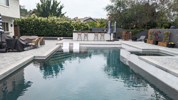 Pool Remodel in San Juan Capistrano - This pool remodel was completed in under 6 weeks. The project included a complete replaster with Pebble Tec, new tile, new poured in place coping, a new custom built BBQ, and all new Casitas pavers in a herringbone patten. Pool Remodel in San Juan Capistrano - This pool remodel was completed in under 6 weeks. The project included a complete replaster with Pebble Tec, new tile, new poured in place coping, a new custom built BBQ, and all new Casitas pavers in a herringbone patten.