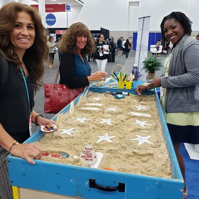 Visit Myrtle Beach Tradeshow - Here are a couple of trade show set up examples. The guests truly enjoyed their time choosing their treasures and decorating their artwork. The pictures below demonstrate how it works and the final results. With our sandbox experience being interactive, it truly allows time to speak with potential customers and receive a 2nd exposure when they return to pick up their artwork. Visit Myrtle Beach Tradeshow - Here are a couple of trade show set up examples. The guests truly enjoyed their time choosing their treasures and decorating their artwork. The pictures below demonstrate how it works and the final results. With our sandbox experience being interactive, it truly allows time to speak with potential customers and receive a 2nd exposure when they return to pick up their artwork.