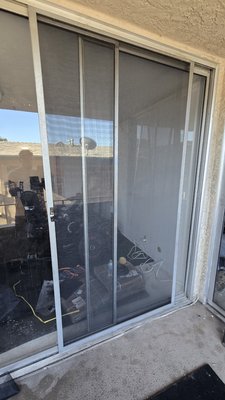 sliding screen door repair. - old screen mesh removed, new one, professional grade, installed