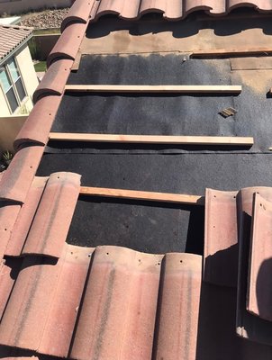 Replacing wood - Roof repair removing damaged plywood and replacing wood ,under tile roof to prevent leaks Replacing wood - Roof repair removing damaged plywood and replacing wood ,under tile roof to prevent leaks