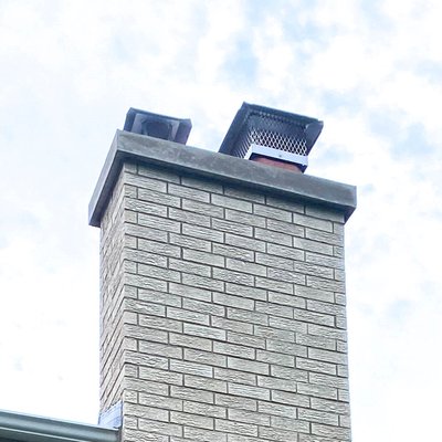 Brick Match, Partial Chimney Rebuild - This chimney was deteriorating from utility liner issues, as well as diverter flashing issues. Utility gases escaping before the top of the chimney damaged brick and mortar. Additionally, the improper diverter flashing caused ice buildup on the chimney near the roof line. We installed a new stainless steel utility liner and extended the diverter flashing. The biggest difficulty in any partial rebuild is the brick match. With enough effort and searching, we found a perfect brick match for this work.