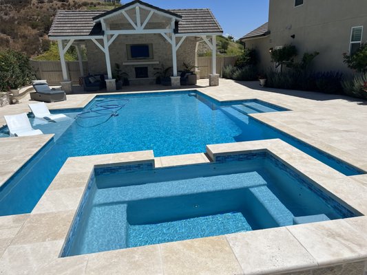 Pool With a View - We built a baja shelf and steps into the pool on opposite sides.  The raised spa with the view of the hill in the background created a peaceful environment.  The homeowners see a good amount of wildlife while enjoying the backyard.