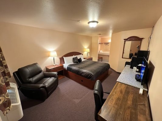 King Studio Suite - Roomy 276 square foot King room with Carpet Floor, Tile in bathroom & Vanity area. High speed WIFI for work and streaming, Work desk and office chair, Roku or mirror your cell phone to TV screen, mini fridge, microwave, soft chair, hair dryer, Dresser with granite top, nightstands. King Studio Suite - Roomy 276 square foot King room with Carpet Floor, Tile in bathroom & Vanity area. High speed WIFI for work and streaming, Work desk and office chair, Roku or mirror your cell phone to TV screen, mini fridge, microwave, soft chair, hair dryer, Dresser with granite top, nightstands.