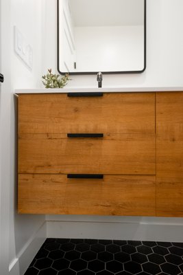 Modern Bathroom Renovation - Our client’s recent bathroom remodel brings together modern elegance and functionality! From the sleek black fixtures that pop against the fresh white subway tiles to the warm wood tones of the custom vanity, every element is designed to create a luxurious, spa-like experience. Our team at Tulip Remodeling ensured every inch of this space was crafted with precision and care, delivering a beautiful and practical result for our client. Watch to see the transformation!