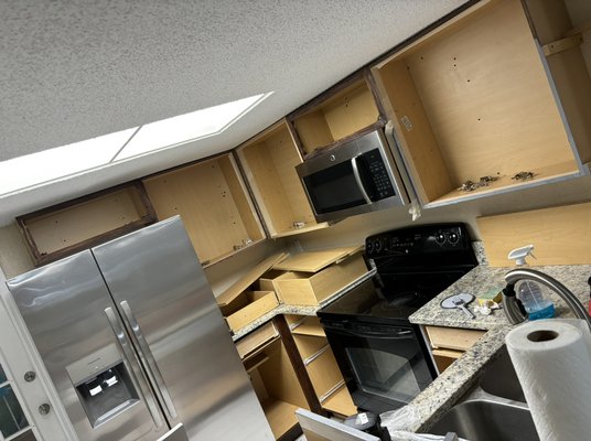 Repainting kitchen cabinets. - This project was to repaint the kitchen cabinets. We removed all the doors, cleaned them of old paint, painted them and installed them back.