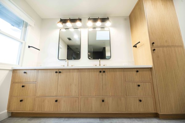 Bathroom Remodeling - Custom Wood Cabinets, Stylish Mirrors, Gray Stone Flooring, and Artful Tile Design the touch of elegance your home needs.