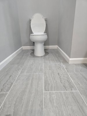 Bathroom Tile Remodel - In this project, the client had old tiles with cracks in her bathroom and desired a more contemporary appearance. We were pleased to remove the outdated ceramic tiles and install new ones to modernize the bathroom.