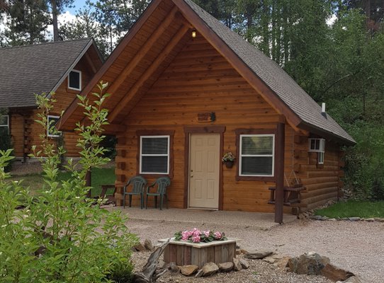 CABIN #2 Sunset Ridge - CABIN #2
Sunset Ridge

Non-Smoking

This cabin has 2 queen beds (one in the bedroom and one in the loft; which has custom log railing), a small hide-a-bed sofa in the living space and 1 full bathroom.

It has a kitchenette with microwave, toaster, coffee pot, under the counter size fridge/freezer, electric skillet, dishes, silverware and cooking utensils.

There is a 6 ft. covered front porch with picnic table and charcoal grill beside it. The cabin has electric heat, AC and Satellite TV.