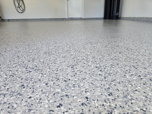 Doing a 3 car garage floor with moisture barrier. - The floor had stain and some indicators of moisture calcium, we started by grinding the floor, we then started patching and vacuum it, after patching we let the materials dry, we the re vacuum to get all debris particles out of the floor as much as possible, after we finish preparing the floor we drop the moisture barrier, we let it dry for more than 12 hours.
we went back the next day buff the floor, mop it and then dropped the epoxy with flakes a full broadcast to cover the entire floor including the stem walls.
we waited 2 hour for the material to fuse and dry at the same time, we then scrape all excess like flakes and then blow and vacuum to get a nice and clean area for us to drop the polyaspartic topcoat a total of 2 days was required to accomplish the job and with the satisfaction of our customers. Doing a 3 car garage floor with moisture barrier. - The floor had stain and some indicators of moisture calcium, we started by grinding the floor, we then started patching and vacuum it, after patching we let the materials dry, we the re vacuum to get all debris particles out of the floor as much as possible, after we finish preparing the floor we drop the moisture barrier, we let it dry for more than 12 hours.
we went back the next day buff the floor, mop it and then dropped the epoxy with flakes a full broadcast to cover the entire floor including the stem walls.
we waited 2 hour for the material to fuse and dry at the same time, we then scrape all excess like flakes and then blow and vacuum to get a nice and clean area for us to drop the polyaspartic topcoat a total of 2 days was required to accomplish the job and with the satisfaction of our customers.