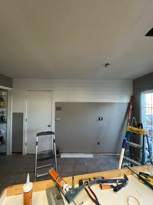 Accent wall - Took a blank wall and added some nickel gap molding, change the casing and baseboard to shaker style . Purchased an old cabinet from habitat humanity and installed a butcher block countertop. 
Will be painting everything and adding a floating shelf above the cabinet