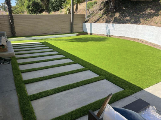 Full Backyard Remodel - Another beautiful and quality project from Manhattan Bridge. This time, a full backyard redesign with new concrete, artificial grass, and a fireplace in Moore.