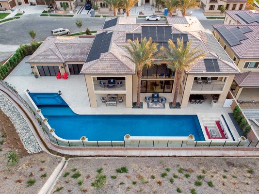 Irvine Backyard Unique Pool - This unique upside-down L-shaped pool design elegantly wraps around the home, maximizing both space and functionality. The upside-down L-configuration creates distinct areas for different activities, allowing for a seamless transition from swimming to lounging. One leg of the upside-down "L" features a spacious swim zone, perfect for laps or relaxation, while the other leg is designed for socializing, with integrated seating and a sleek fire feature. The geometric layout not only complements the modern architecture of the home but also enhances the flow between indoor and outdoor living spaces, making it an ideal centerpiece for luxury gatherings and serene moments alike. Irvine Backyard Unique Pool - This unique upside-down L-shaped pool design elegantly wraps around the home, maximizing both space and functionality. The upside-down L-configuration creates distinct areas for different activities, allowing for a seamless transition from swimming to lounging. One leg of the upside-down "L" features a spacious swim zone, perfect for laps or relaxation, while the other leg is designed for socializing, with integrated seating and a sleek fire feature. The geometric layout not only complements the modern architecture of the home but also enhances the flow between indoor and outdoor living spaces, making it an ideal centerpiece for luxury gatherings and serene moments alike.