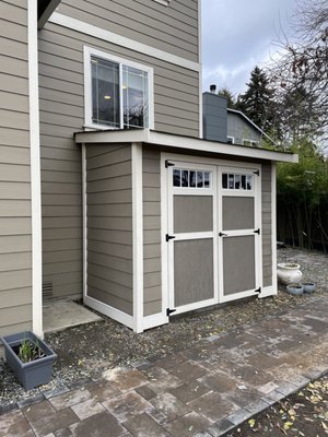 Forester Style Shed 9W X 5D - It is becoming more common that whether you live in the city or newer housing developments our backyard and front yard space is getting smaller. This Forester Shed is a great option for customers who have limited outdoor space but are in need of extra storage. These smaller sheds are often used to store bicycles, gardening tools, ect.
We were able to install this storage shed up against the home to avoid taking additional outdoor space. The customer was also able to provide us with their homes paint color in order for the shed to match perfectly. For an additional fee we offer a painting package where when given brand, color name and number our builders at The Original Mini Barns will paint your shed for you! Forester Style Shed 9W X 5D - It is becoming more common that whether you live in the city or newer housing developments our backyard and front yard space is getting smaller. This Forester Shed is a great option for customers who have limited outdoor space but are in need of extra storage. These smaller sheds are often used to store bicycles, gardening tools, ect.
We were able to install this storage shed up against the home to avoid taking additional outdoor space. The customer was also able to provide us with their homes paint color in order for the shed to match perfectly. For an additional fee we offer a painting package where when given brand, color name and number our builders at The Original Mini Barns will paint your shed for you!