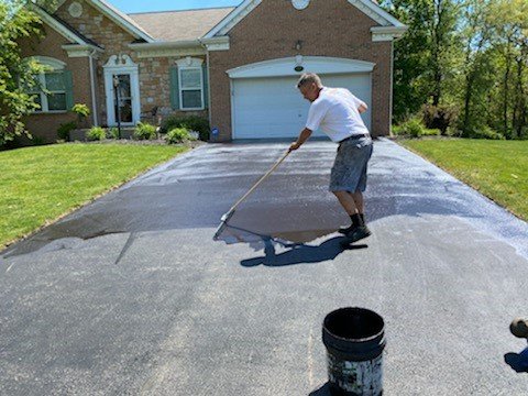 Before and after driveway sealcoating by Professional Driveway Sealers - The before picture is David is applying sealcoating to a local residents driveway with a squeege. The after picture is a beautiful driveway that is protected from the enviorment with sealcoating. Before and after driveway sealcoating by Professional Driveway Sealers - The before picture is David is applying sealcoating to a local residents driveway with a squeege. The after picture is a beautiful driveway that is protected from the enviorment with sealcoating.