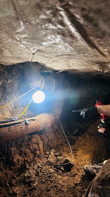 Tunnel - Tunneled under home to fix breaks in the main trunk line. The old cast iron pipe which broke upon removal due to age and decay.