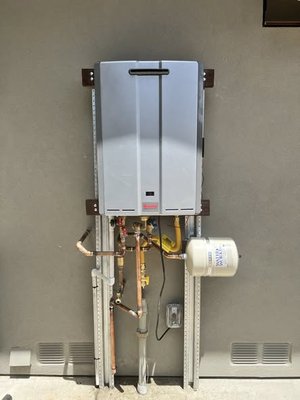 Tankless water heater installation - Tankless water heater installation with dedicated recirculating line to provide faster hot water, improved efficiency, and consistent performance throughout the home. Tankless water heater installation - Tankless water heater installation with dedicated recirculating line to provide faster hot water, improved efficiency, and consistent performance throughout the home.