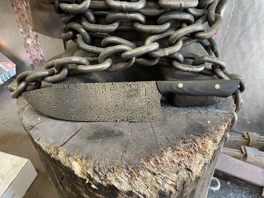 Custom Damascus Chef Knife - This was a custom ordered chef knife. The blade is forged from 200 layers of 1095 and 15n20 that I forged in hose! The handle is black suretouch G10 with moasic pins! If you are interested in your own custom knife, contact me today to get started. Custom Damascus Chef Knife - This was a custom ordered chef knife. The blade is forged from 200 layers of 1095 and 15n20 that I forged in hose! The handle is black suretouch G10 with moasic pins! If you are interested in your own custom knife, contact me today to get started.