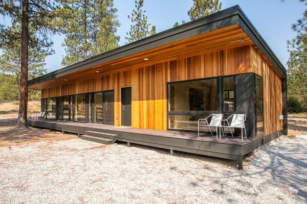 Modern Cabin - This sleek, modern cabin blends rustic charm with contemporary design. The interior features beautiful wood paneling on both the floors and walls, creating a warm and inviting atmosphere. Custom-built bunk beds provide cozy sleeping quarters, perfect for family and guests. A wood burning fireplace serves as the heart of the living space, offering a cozy retreat after outdoor adventures.

The cabin’s exterior boasts striking cedar siding, blending seamlessly with the natural surroundings. Large modern windows bring in ample natural light and offer breathtaking views of the nearby forest. For modern convenience, an electric car charger keeps you ready to explore the surrounding national forest and trails.

This cabin is a perfect mix of rugged outdoors and modern living.