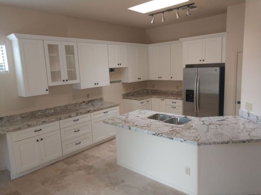 Sunset Canyon Kitchen & Bathroom Remodel - This kitchen and bathroom remodel features beautiful 2cm Sunset Canyon prefabricated granite countertops installed throughout both spaces for a cohesive and timeless design. The kitchen combines bright white shaker cabinets with the natural movement and warm earth tones of the granite to create a clean, welcoming atmosphere. A large island with an undermount stainless steel sink provides additional workspace and seating, making the kitchen both functional and visually striking.

In the bathroom, the matching Sunset Canyon granite was continued onto the double vanity countertop to tie the overall design together. The combination of modern square sinks, white cabinetry, and natural stone creates a fresh and elegant look while maintaining durability for everyday use.

GMT Stoneworks completed the countertop fabrication and installation, helping transform these areas into updated spaces designed for both style and long-term performance.