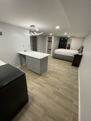 Basement remodel in Brooklyn - Basement was beautifully finished in Brooklyn. Space was optimized for owners need. Open concept, kitchen with island and bathroom. Floors finished with wood like porcelain tile. LED lights installed in the ceiling. Basement remodel in Brooklyn - Basement was beautifully finished in Brooklyn. Space was optimized for owners need. Open concept, kitchen with island and bathroom. Floors finished with wood like porcelain tile. LED lights installed in the ceiling.