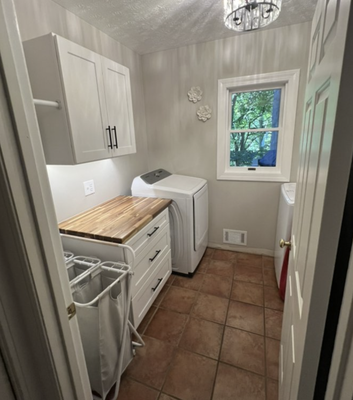 Laundry Room Renovation - This laundry room was just outdated, no practical room for storage and use of space.  We added a beautiful butcher block counter with cabinets to brighten up the space.  The undermount sink and cabinet lighting, give this laundry room a finish that makes you just enjoy your time doing all that laundry.