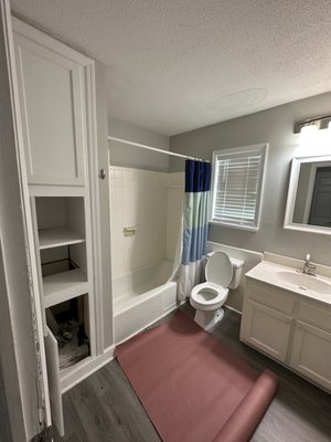 Bathroom remodel - This bathroom remodel was in a small apartment in West Ashley. The clients did not have washer and dryer access in the apartment so we added the small stackable units next to the walk-in shower that used to be a cast-iron tub.