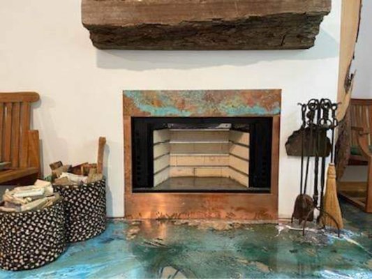 Copper surround - We repaired the inside of this firebox by remove the old damaged cracked panels, and installed our brick track system that is guaranteed to last longer than firebox panels. We then poured a fireclay bottom and installed a copper surround.