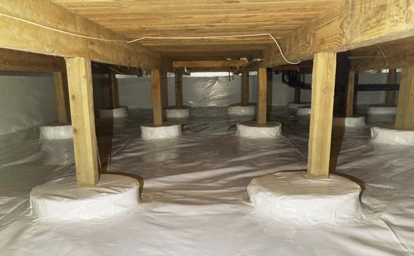 Apartment Complex Crawlspace Encapsulation - 2020 - This space was holding mold in the old fiberglass insulation. The water weight was dragging it down and causing a mess. The smell was now in the apartment building. To fix it up we installed a full crawlspace encapsulation. This includes TripleSafe Sump pumps, Drainage matting, TerraBlock Insulation, SilverGlo insulation, CleanSpace vapor barrier, SaniDry dehumidifier, as well as new crawlspace entrances.