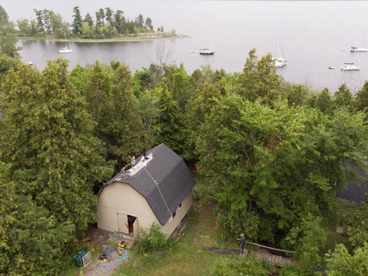 Cottage Re-Roof - The Aquila Roofing Crew installed this new roof out at Pinhey Point near Dunrobin.  the Cottage did't have much insulation (or attic space) so we installed ice and water shield to the whole roof deck before shingling.  the Final result looks great! CertainTeed Landmark Shingles in Moire Black