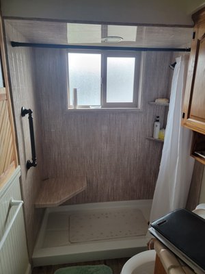 Tim & Linda-Bathroom Remodel - Tim & Linda had a tub with a high threshold and a soffit with a low ceiling, as a result it was hard for them to get in-and-out of the Shower and the dangerously slippery bathroom floor only exacerbated the problem. We gutted the whole tile shower and replaced it with a Seamless walk-in shower and a bench. We also replaced the old tile floor with some slip resistant LVP that's much easier to keep clean, now they use this bathroom regularly! Tim & Linda-Bathroom Remodel - Tim & Linda had a tub with a high threshold and a soffit with a low ceiling, as a result it was hard for them to get in-and-out of the Shower and the dangerously slippery bathroom floor only exacerbated the problem. We gutted the whole tile shower and replaced it with a Seamless walk-in shower and a bench. We also replaced the old tile floor with some slip resistant LVP that's much easier to keep clean, now they use this bathroom regularly!