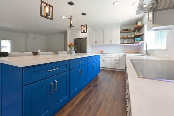 Spacious Island Kitchen Remodel - Elegant galley kitchen with pendant lighting, marble counter tops, large island and hardwood floors