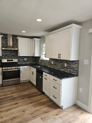 Kitchen Remodel - Removed old kitchen, walls, breakfast bar.
Reconfigured layout, new cabinets, Quartz counter, vented exhaust. Kitchen Remodel - Removed old kitchen, walls, breakfast bar.
Reconfigured layout, new cabinets, Quartz counter, vented exhaust.