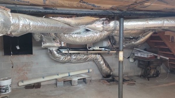 HEAT PUMP SYSTEM IN BASEMENT - Transitioned air handler from a vertical to a horizontal application and modified ductwork to improve airflow. HEAT PUMP SYSTEM IN BASEMENT - Transitioned air handler from a vertical to a horizontal application and modified ductwork to improve airflow.