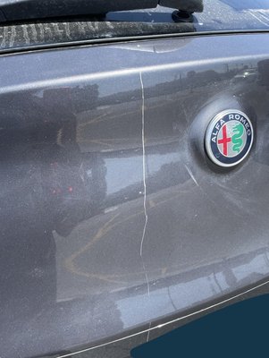 Alfa Romeo Stelvio | Deep Scratch Repair - For this job, we repaired a deep scratch on the liftgate of a 2020 Alfa Romeo Stelvio. We make sure to cover up all areas that will not be painted and the floor for protection. We provide a lifetime guarantee on all of our work for our client's peace of mind!