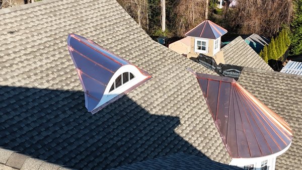 ASPHALT ROOF WITH DETAILS IN COOPER - We completed a new construction roofing project in New York, contracted through our website. The main roof was done with asphalt shingles, while the flat roof sections used EPDM. Copper details were installed in valleys, domes, and chimney flashing for a high-end finish. ASPHALT ROOF WITH DETAILS IN COOPER - We completed a new construction roofing project in New York, contracted through our website. The main roof was done with asphalt shingles, while the flat roof sections used EPDM. Copper details were installed in valleys, domes, and chimney flashing for a high-end finish.