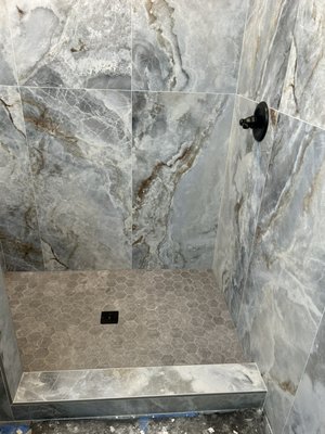 Last Shower Remodel of 2024 - This Shower was the last update needed in this house. We installed 24x48 inch tiles on the walls, and gray mosaic tiles on the floor. Large Format Tiles always make showers look modern and clean. Owner was supper happy with the results. Last Shower Remodel of 2024 - This Shower was the last update needed in this house. We installed 24x48 inch tiles on the walls, and gray mosaic tiles on the floor. Large Format Tiles always make showers look modern and clean. Owner was supper happy with the results.