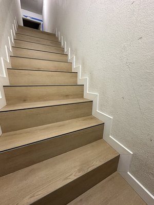 900 square feet Replacing floors and stairs with laminate and installing baseboards - 900 square feet Replacing floors and stairs with laminate and installing baseboards, painting and cocking.  Each step of the staircase was framed with a plinth.